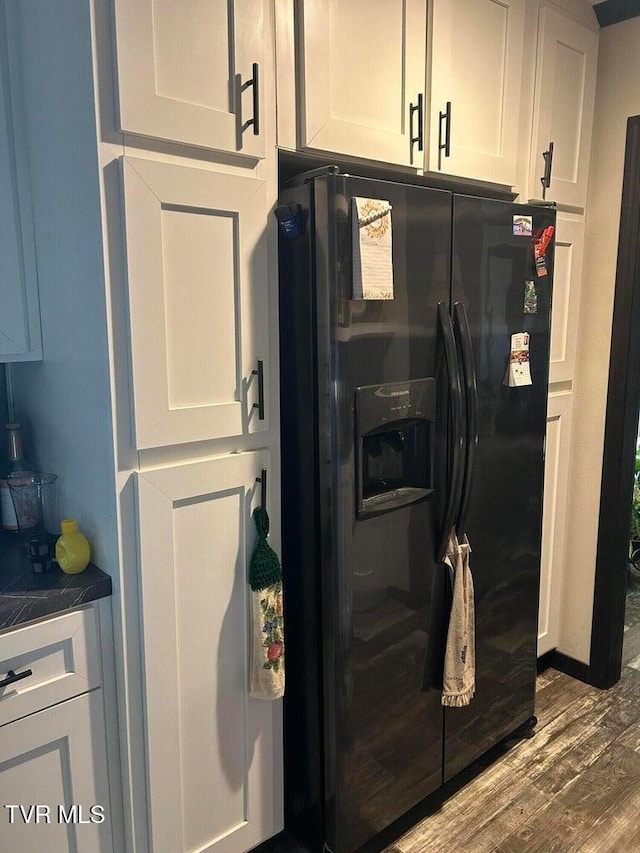 kitchen with white cabinetry, dark hardwood / wood-style flooring, and black refrigerator with ice dispenser