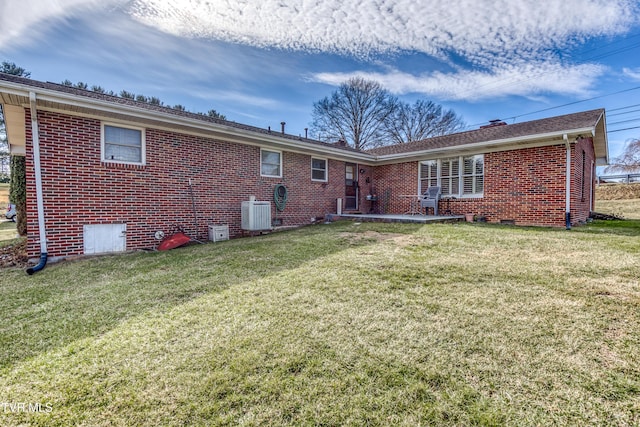 back of property with cooling unit and a lawn