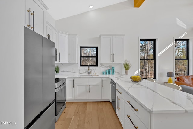 kitchen featuring light stone countertops, white cabinets, and appliances with stainless steel finishes