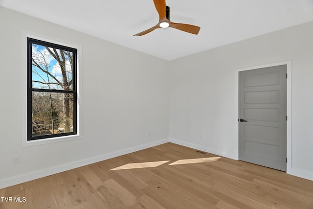 unfurnished room with ceiling fan and light wood-type flooring