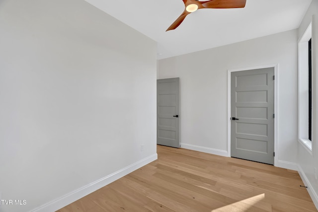 unfurnished room featuring ceiling fan and light wood-type flooring