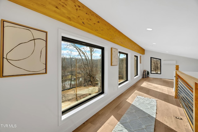 hallway featuring light wood-type flooring and a wall unit AC