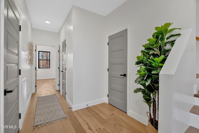 corridor with light hardwood / wood-style floors