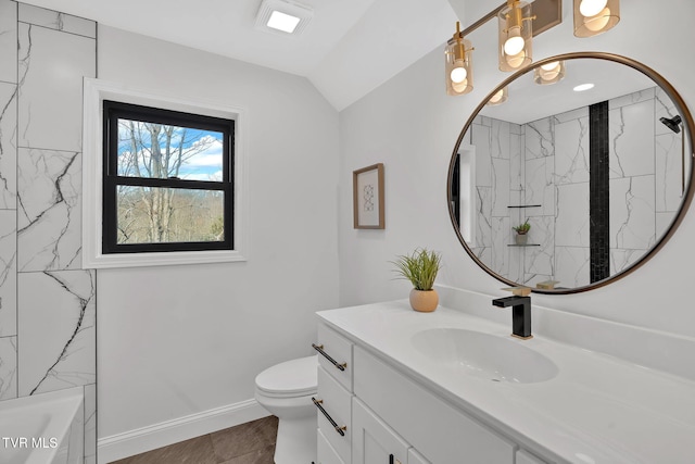 bathroom with vanity, vaulted ceiling, and toilet