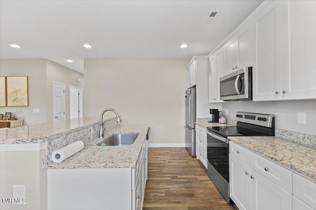 kitchen featuring sink, white cabinetry, stainless steel appliances, dark hardwood / wood-style floors, and an island with sink