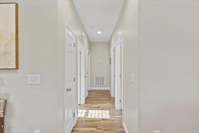 hall with light hardwood / wood-style flooring