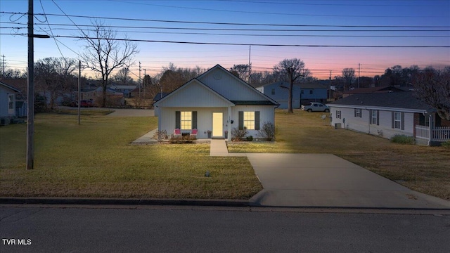 view of front of house with a lawn and a porch