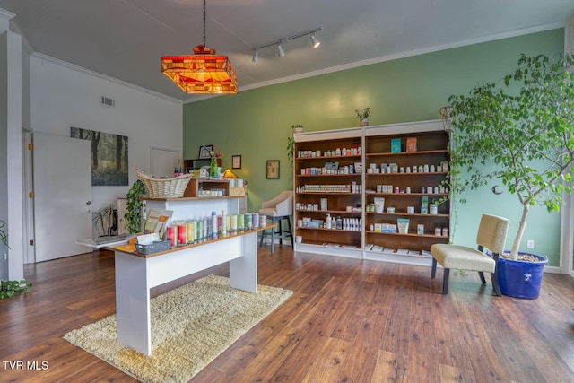 home office featuring crown molding, track lighting, and dark hardwood / wood-style flooring