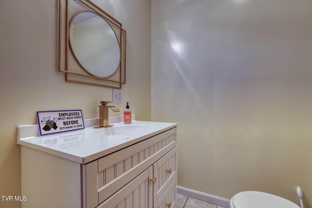 bathroom with vanity, tile patterned floors, and toilet