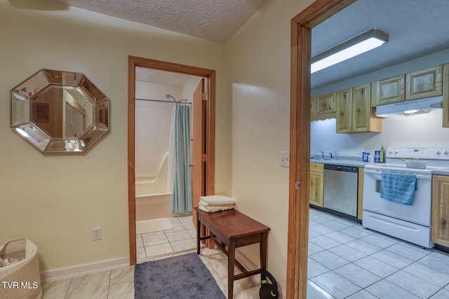 kitchen featuring sink, a textured ceiling, light tile patterned floors, stainless steel dishwasher, and white electric stove