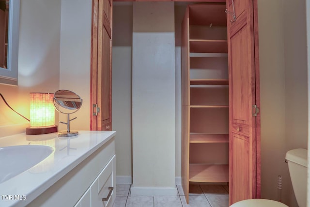 bathroom featuring vanity, tile patterned floors, and toilet