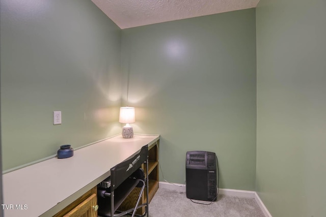 carpeted office space with a textured ceiling