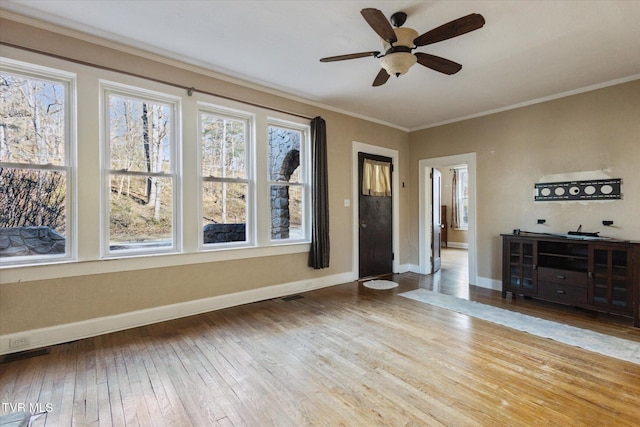 entrance foyer with light wood-type flooring, visible vents, crown molding, and baseboards