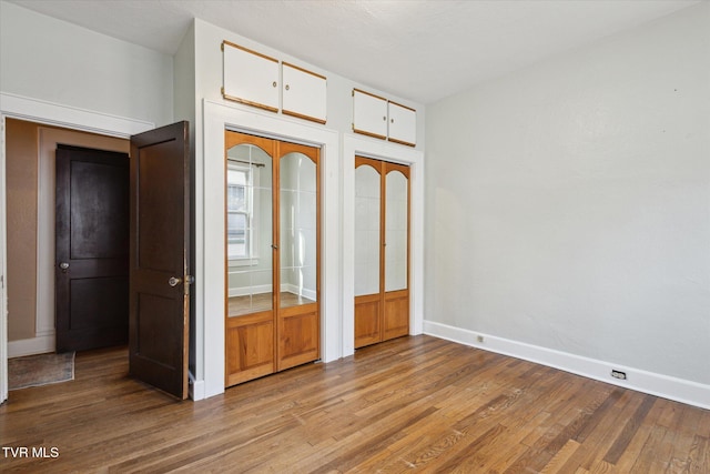 unfurnished bedroom with light wood-style flooring and baseboards