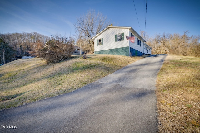 view of home's exterior with a yard