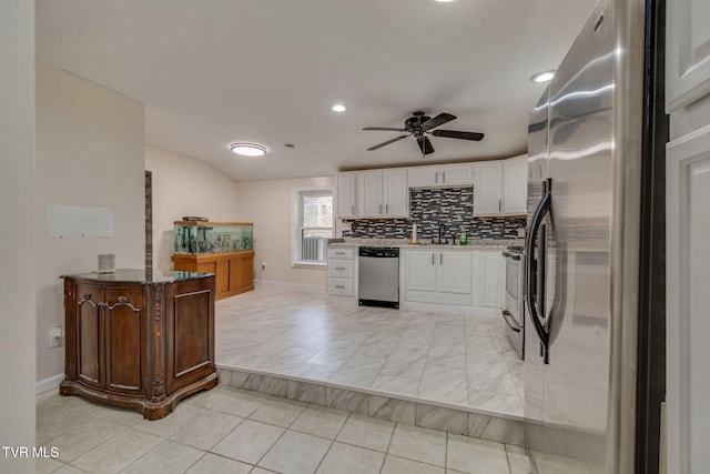 kitchen with sink, ceiling fan, appliances with stainless steel finishes, white cabinetry, and decorative backsplash