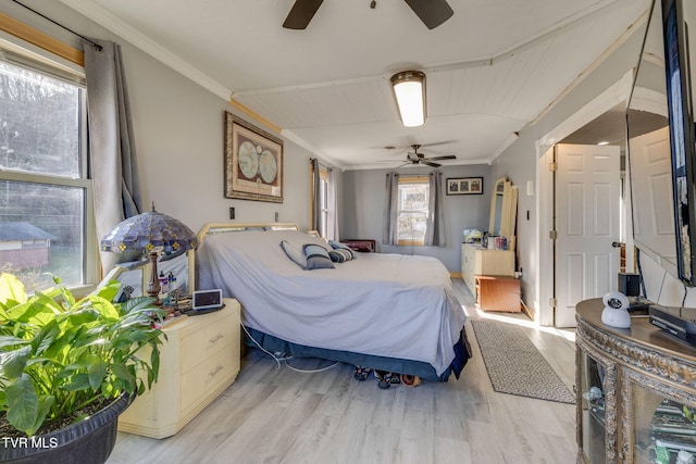 bedroom featuring ceiling fan, ornamental molding, and light hardwood / wood-style floors