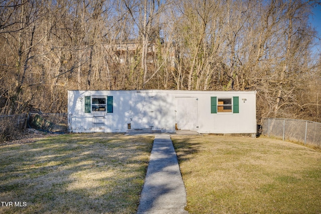 view of outdoor structure featuring a lawn