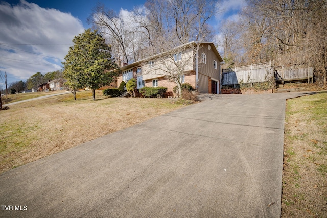 view of side of property with a garage and a lawn