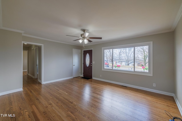 foyer with crown molding, ceiling fan, and wood-type flooring