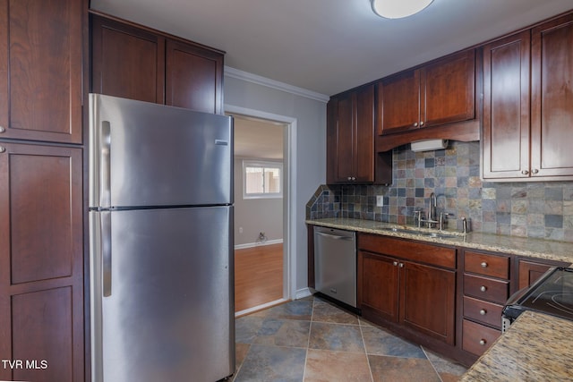 kitchen with appliances with stainless steel finishes, sink, backsplash, and light stone counters