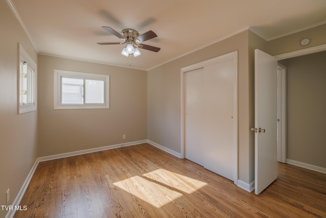 unfurnished bedroom featuring crown molding, ceiling fan, and light hardwood / wood-style flooring