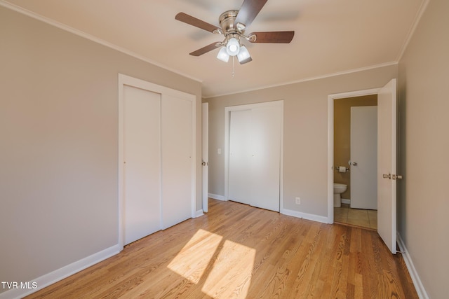 unfurnished bedroom featuring crown molding, ceiling fan, light wood-type flooring, and a closet