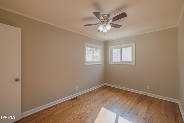 spare room featuring light hardwood / wood-style flooring, ornamental molding, and ceiling fan