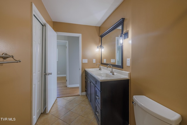 bathroom featuring tile patterned floors, vanity, and toilet