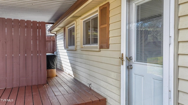 entrance to property featuring a wooden deck