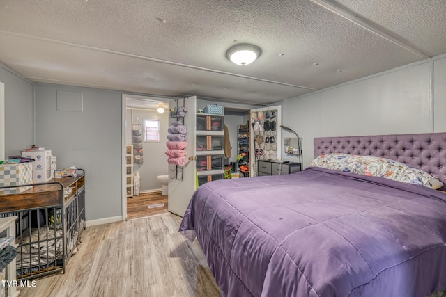 bedroom featuring a textured ceiling and light wood-type flooring