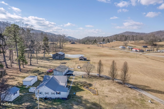 drone / aerial view featuring a mountain view and a rural view