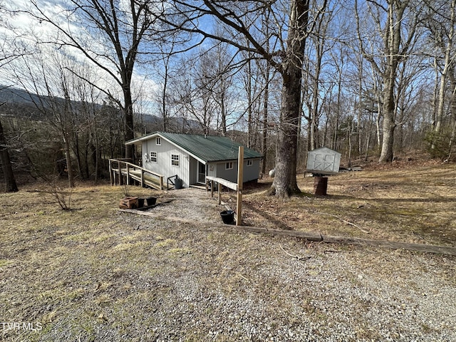 view of front of home with a shed