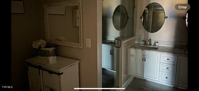 bathroom with a sink and stacked washing maching and dryer