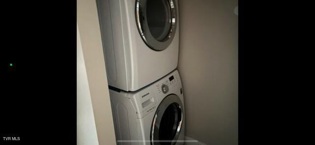 laundry area with laundry area and stacked washer / dryer