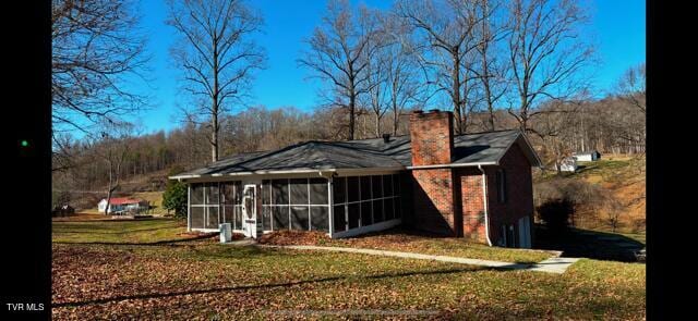 view of outbuilding with a sunroom