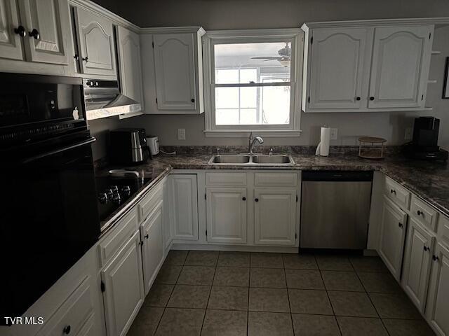 kitchen featuring dark countertops, black appliances, white cabinetry, a sink, and exhaust hood