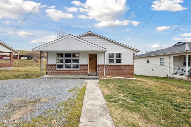 bungalow with a front yard and covered porch