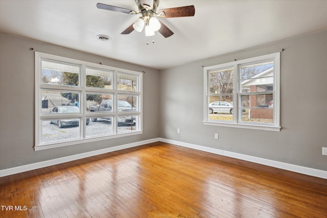 unfurnished room with hardwood / wood-style floors and ceiling fan