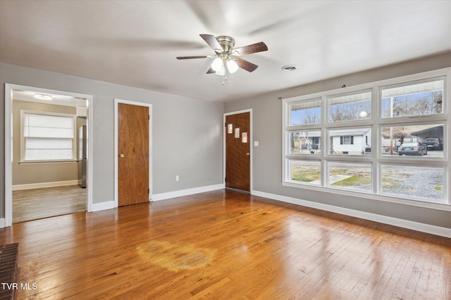 empty room featuring ceiling fan and light wood-type flooring