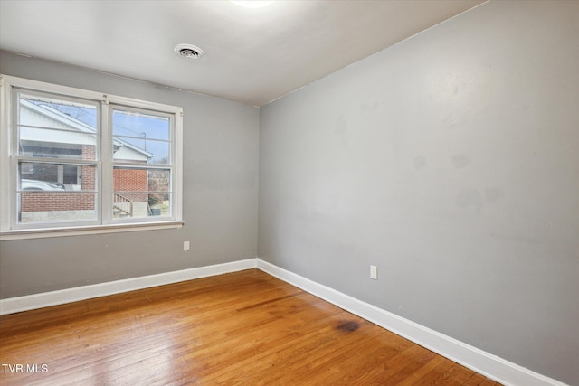 empty room with hardwood / wood-style flooring