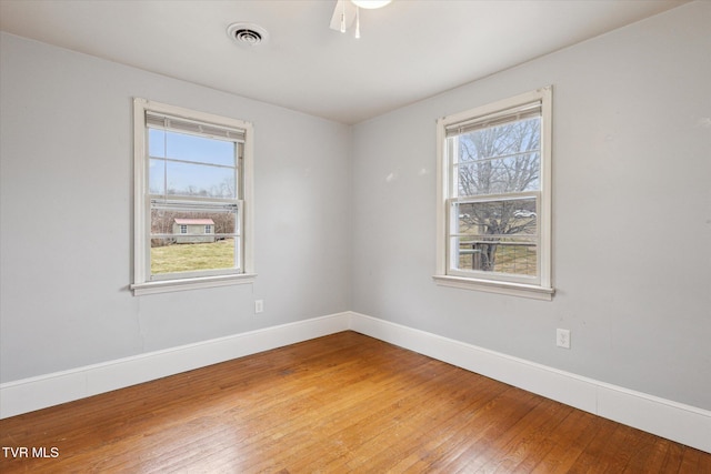 unfurnished room featuring hardwood / wood-style flooring