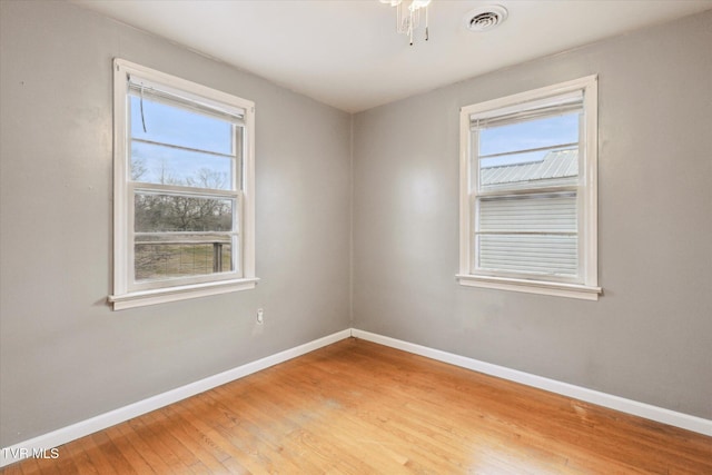 unfurnished room featuring hardwood / wood-style flooring