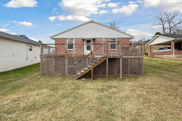 back of property with a lawn, a carport, and a deck