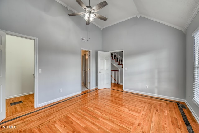 unfurnished bedroom featuring ceiling fan, ornamental molding, high vaulted ceiling, and light hardwood / wood-style flooring