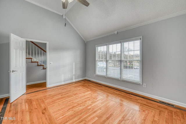 spare room with ceiling fan, lofted ceiling, ornamental molding, and light hardwood / wood-style floors