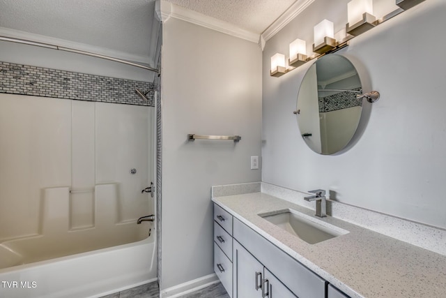 bathroom featuring ornamental molding, bathtub / shower combination, a textured ceiling, and vanity