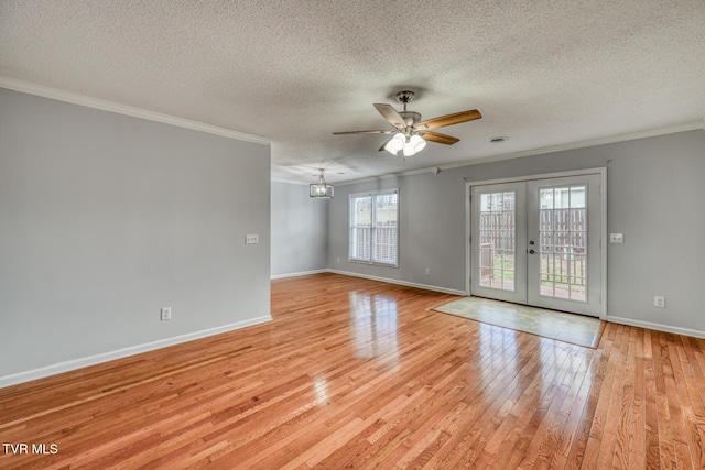 spare room with french doors, ceiling fan, crown molding, and light hardwood / wood-style flooring