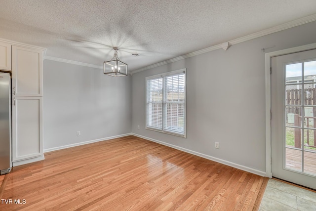 unfurnished dining area with crown molding, a wealth of natural light, light hardwood / wood-style floors, and a chandelier