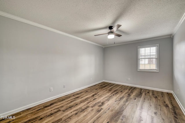 spare room featuring ceiling fan, ornamental molding, dark hardwood / wood-style floors, and a textured ceiling